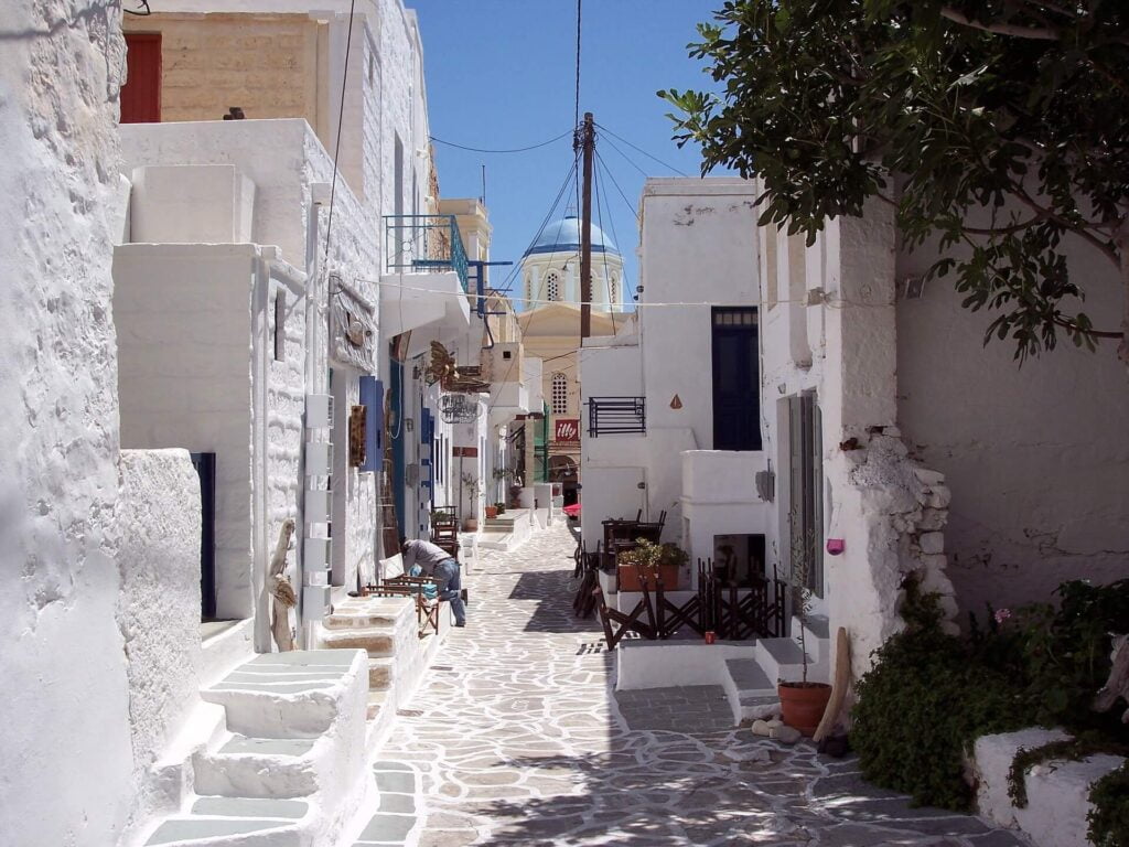 A narrow cobbled lane on the Greek island of Kimolos is lined with whitewashed buildings